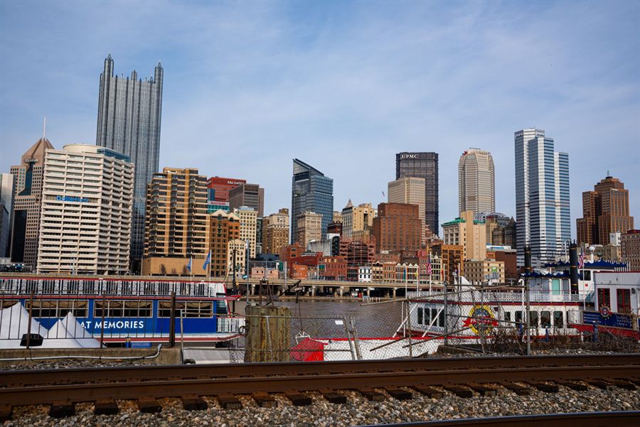 Pittsburgh skyscrapers above a riverboat moored on the riverfront